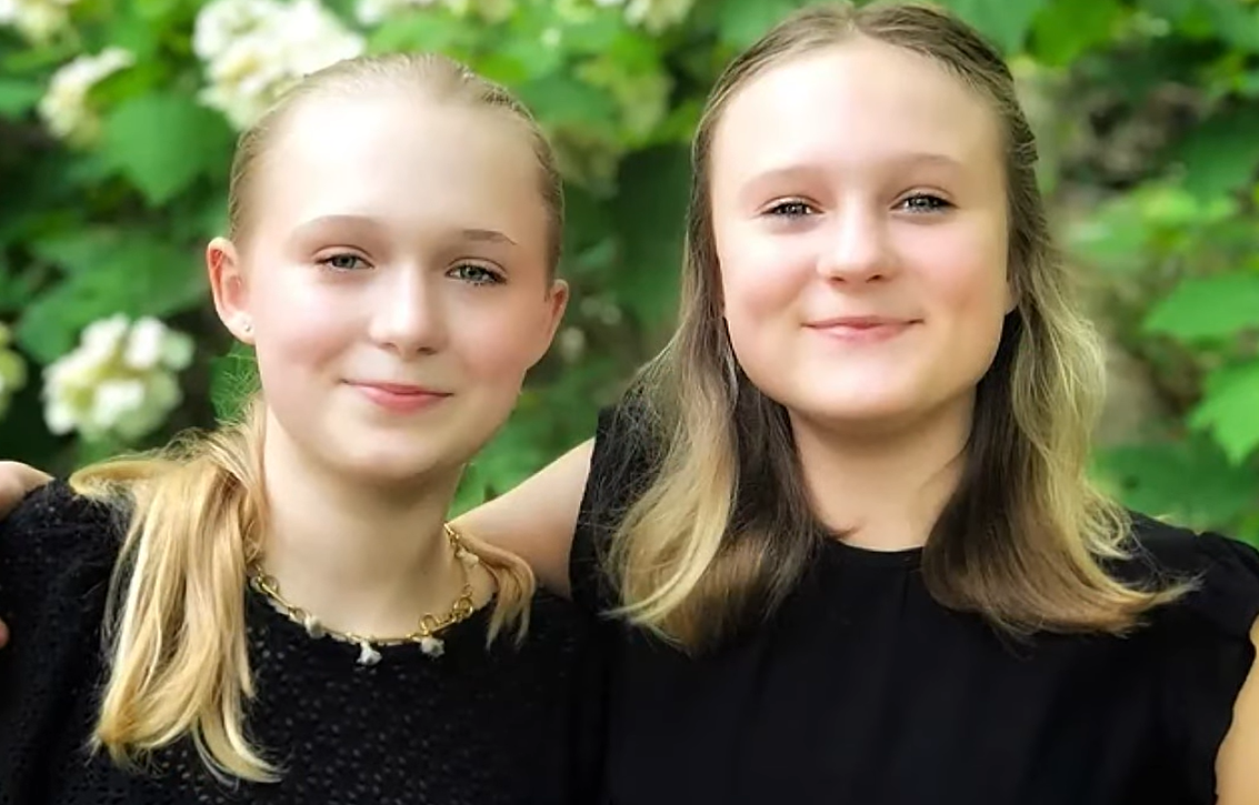 two sisters wearing matching shirts