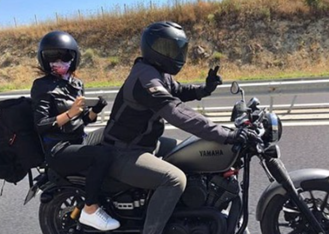 two adults on a motorcycle 