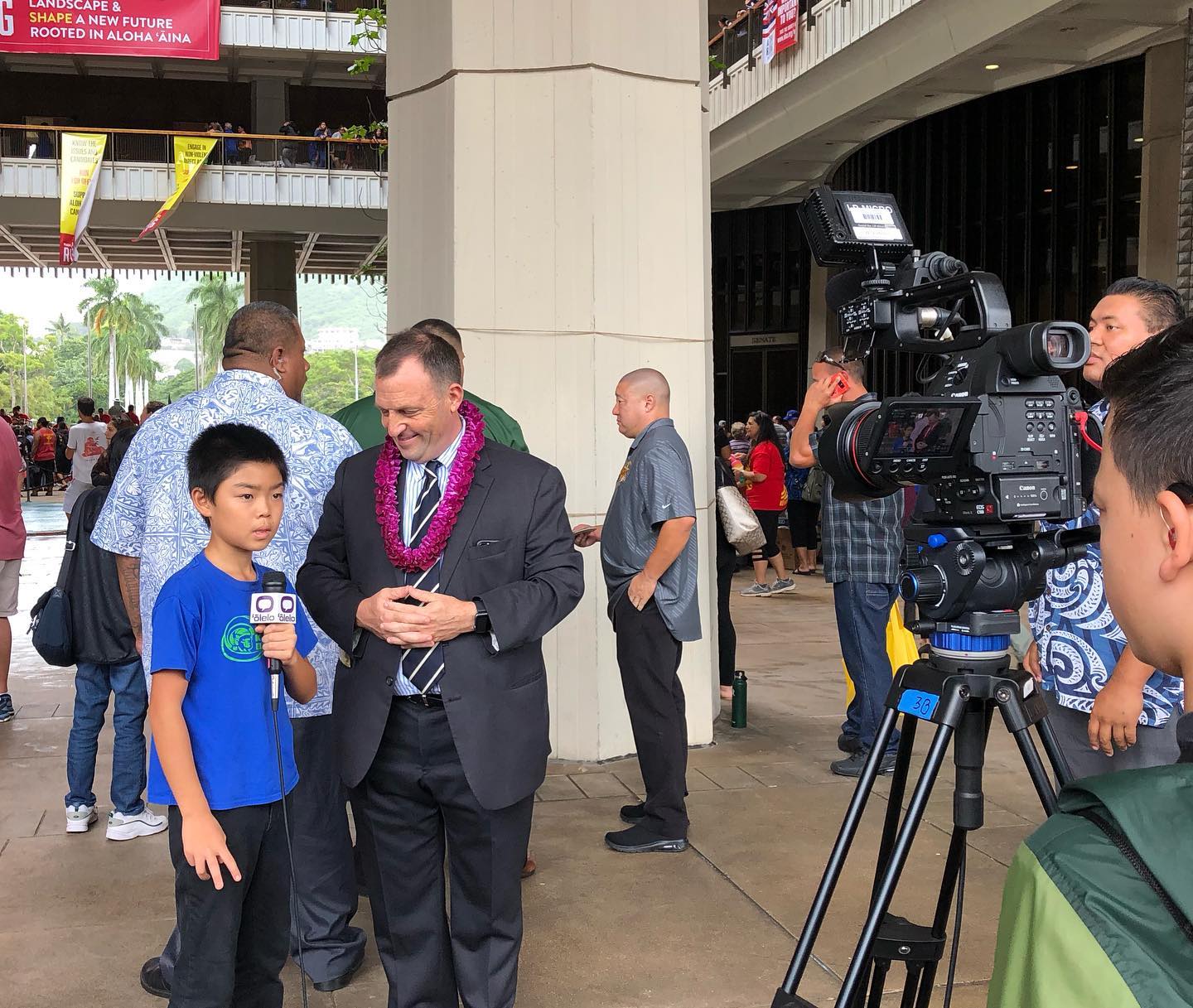 little boy being interviewed by a man from the news