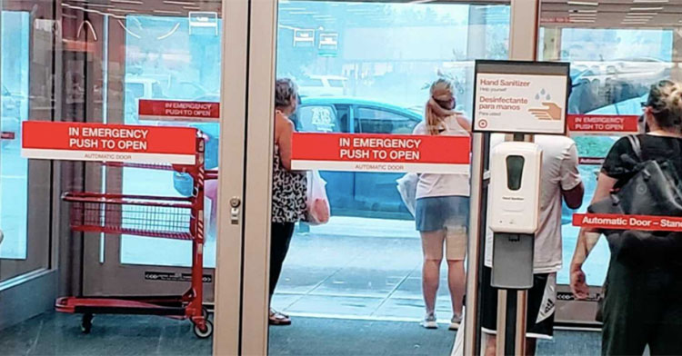 shoppers waiting to leave target while it's pouring rain