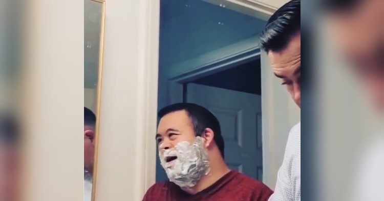 man helps his son shave