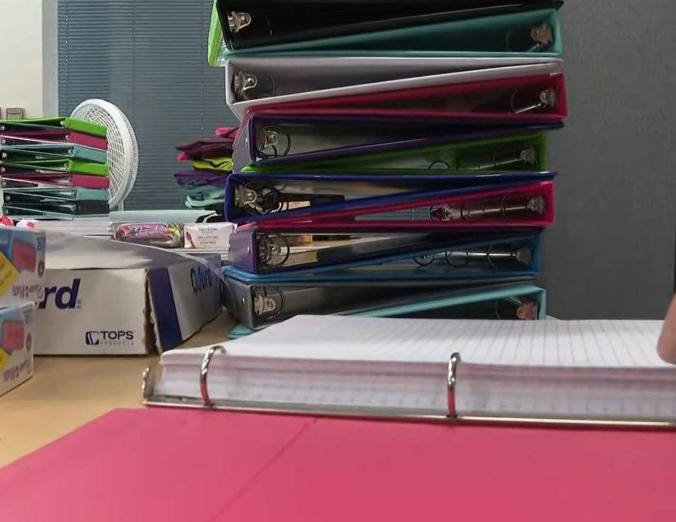 stack of binders and other school supplies