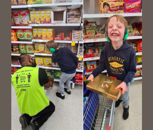 supermarket employee showing little boy cookies next to little boy holding box of chocolates