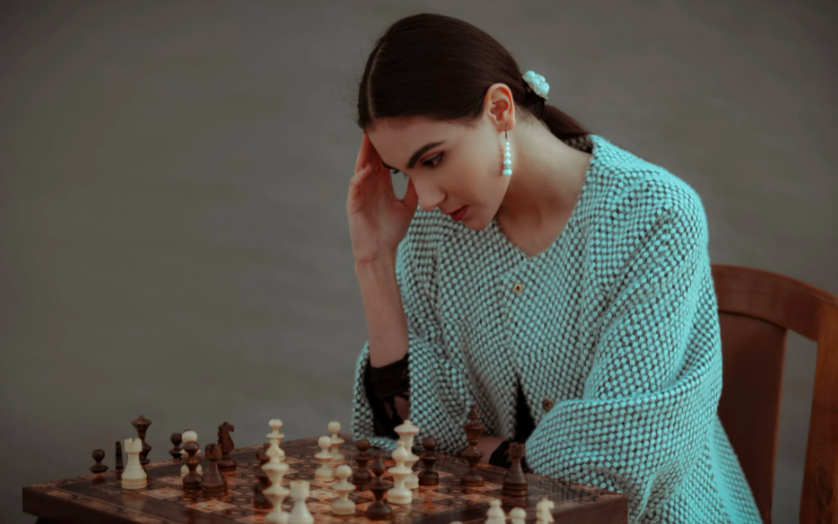 woman thinking about chess moves