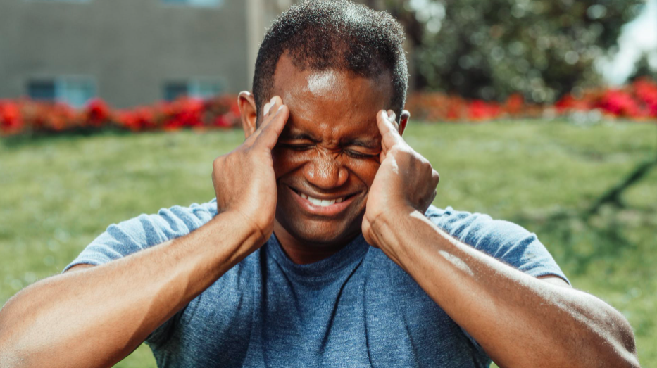 man covering face with hands