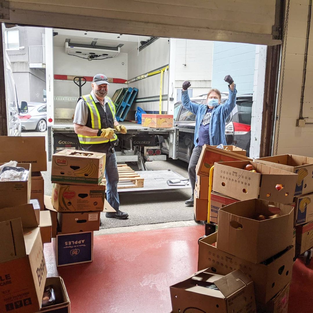 men loading produce into truck