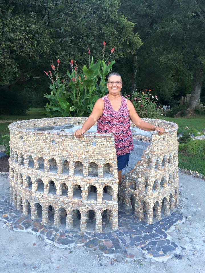 woman standing in middle of pebble Colosseum