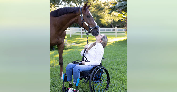woman in wheelchair kissing horse
