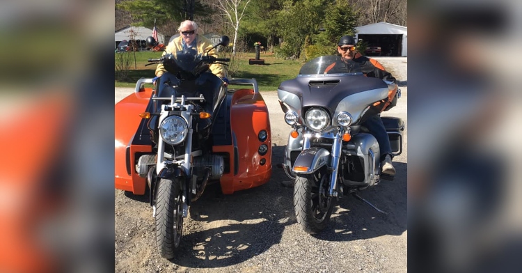 two men sitting on their motorcycles