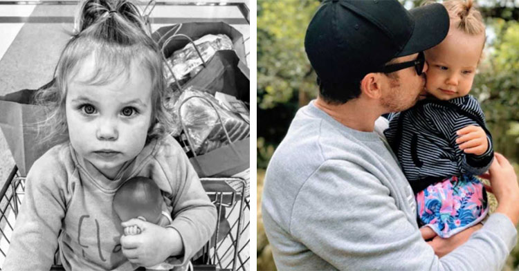 little girl in shopping cart next to dad holding baby girl