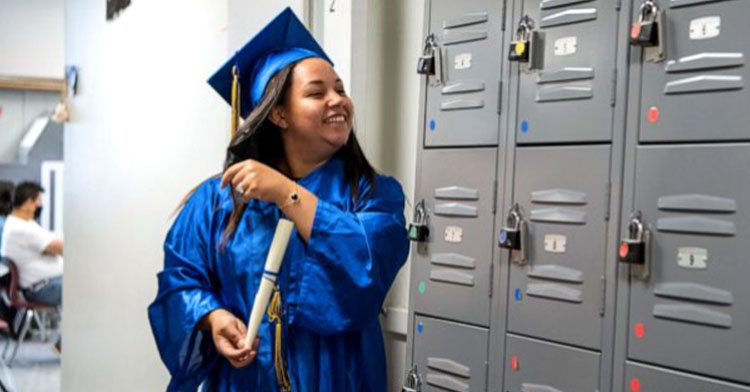 mom holding diploma by lockers