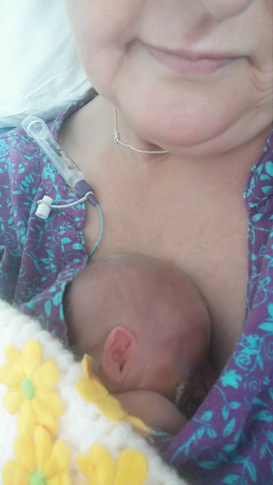 woman holding her premature baby to her chest