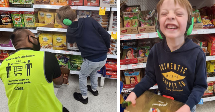 supermarket worker helping little boy next to little boy beaming holding box of chocolates