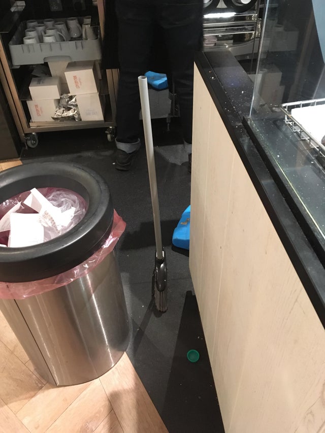 a broom standing straight up by itself