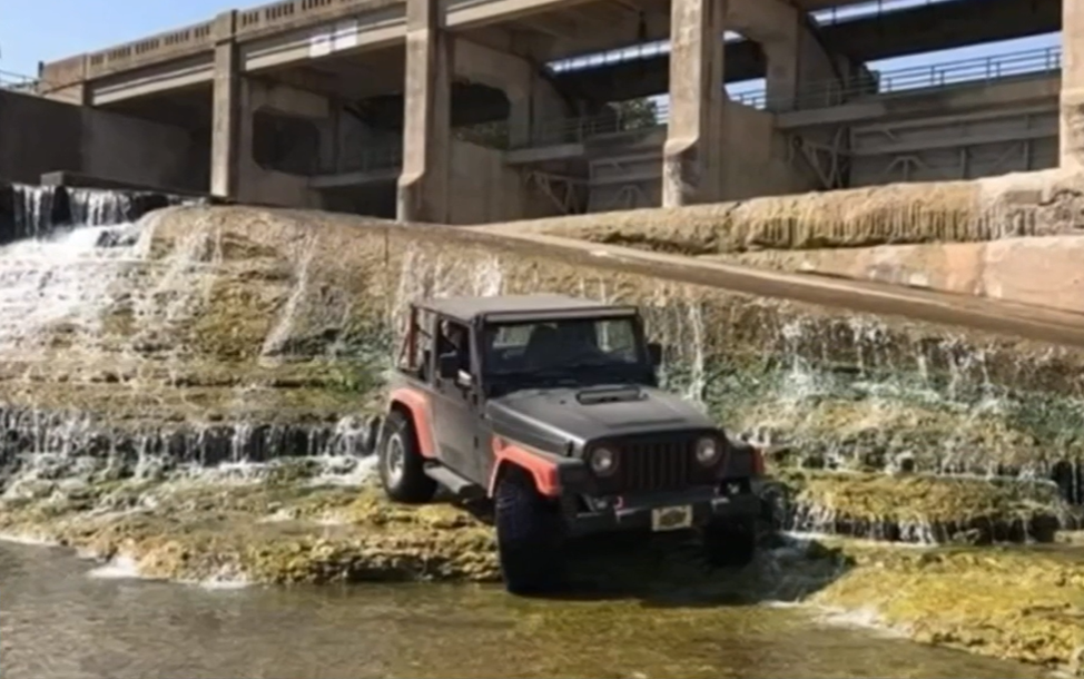 jeep on rocks next to water