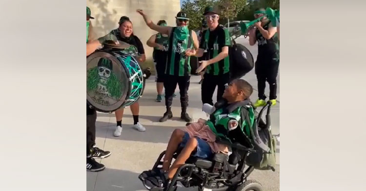 marching band playing for teen in wheelchair