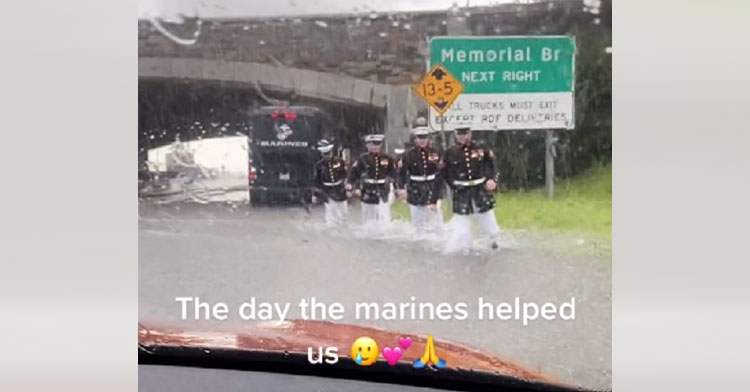 marines wading through flash flood