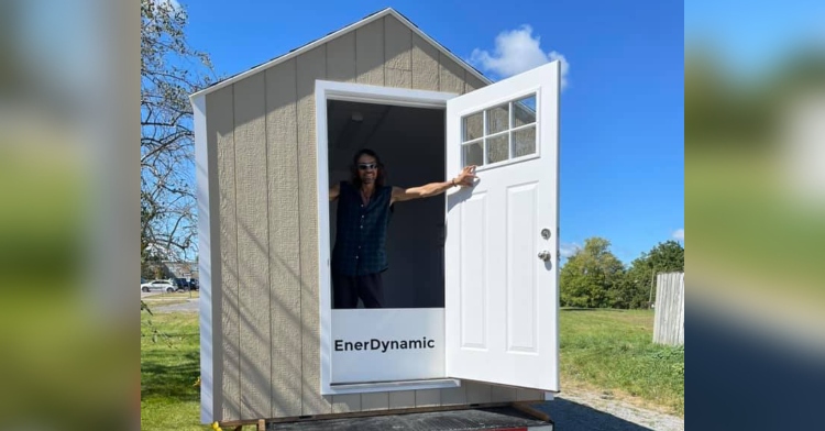 micro home on the back of a truck with a man inside who just opened the door