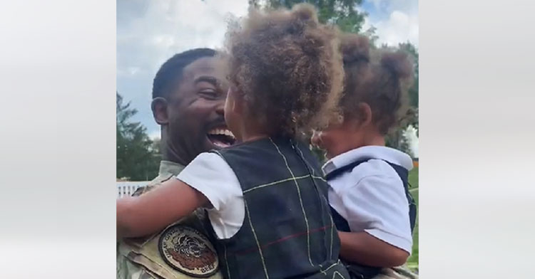 little girls hugging military dad