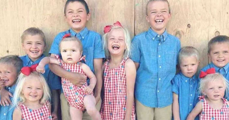 11 kids in matching red and blue outfits