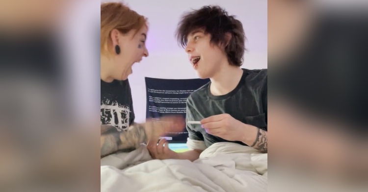 woman and man excited after looking getting a positive pregnancy test result