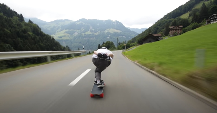 man skateboarding down mountain