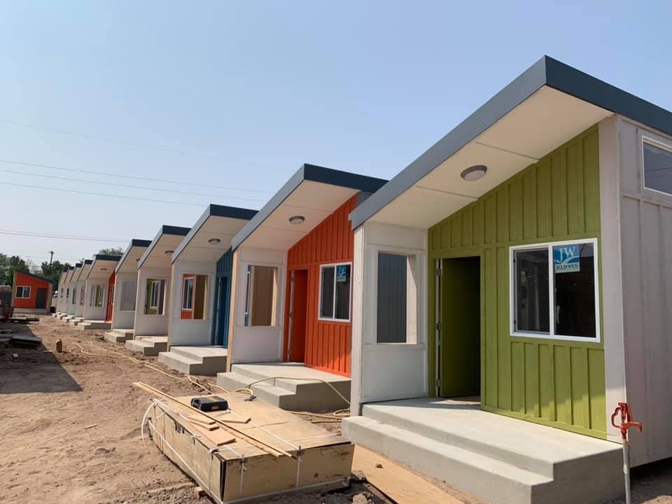 row of colorful tiny houses under construction 