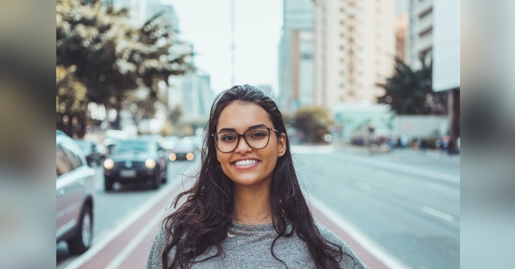 woman with glasses smiling