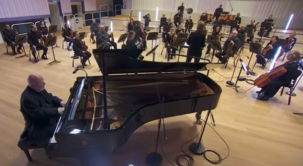 Paul Harvey playing piano with BBC Orchestra