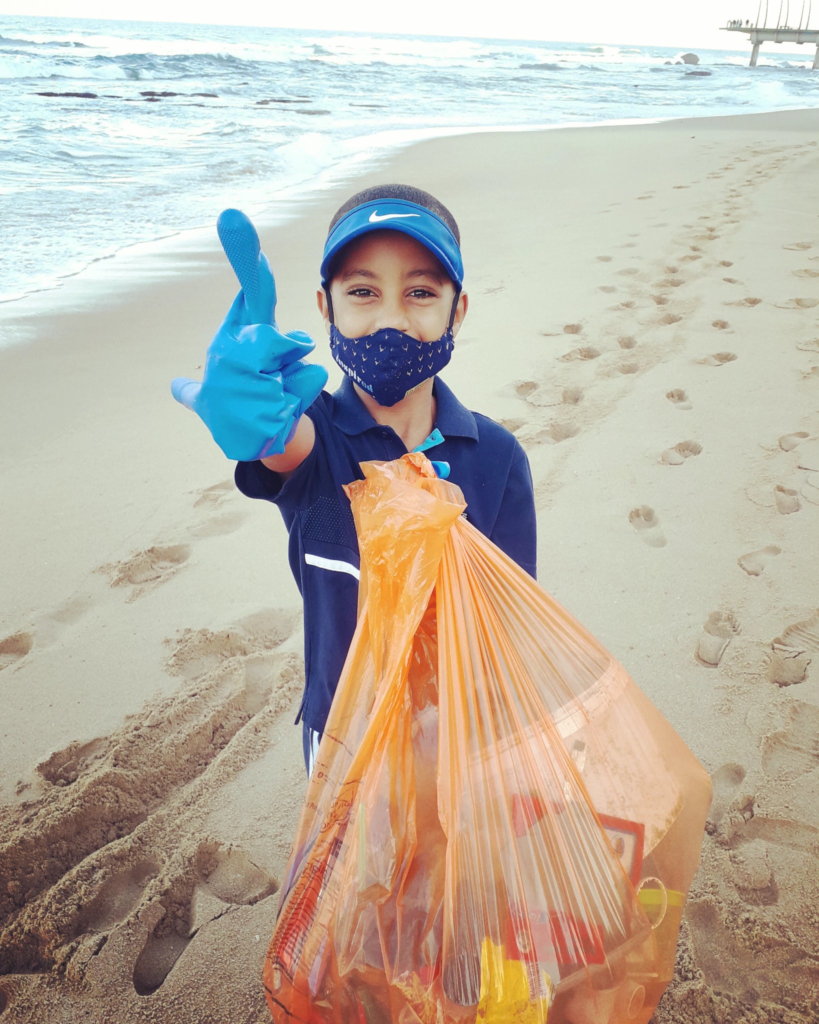 Romario Valentine cleaning beach