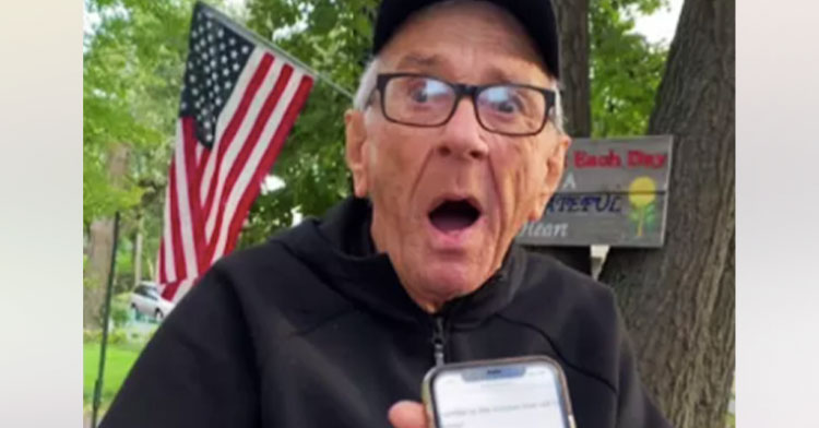 79-year-old veteran looking surprised with phone by his face