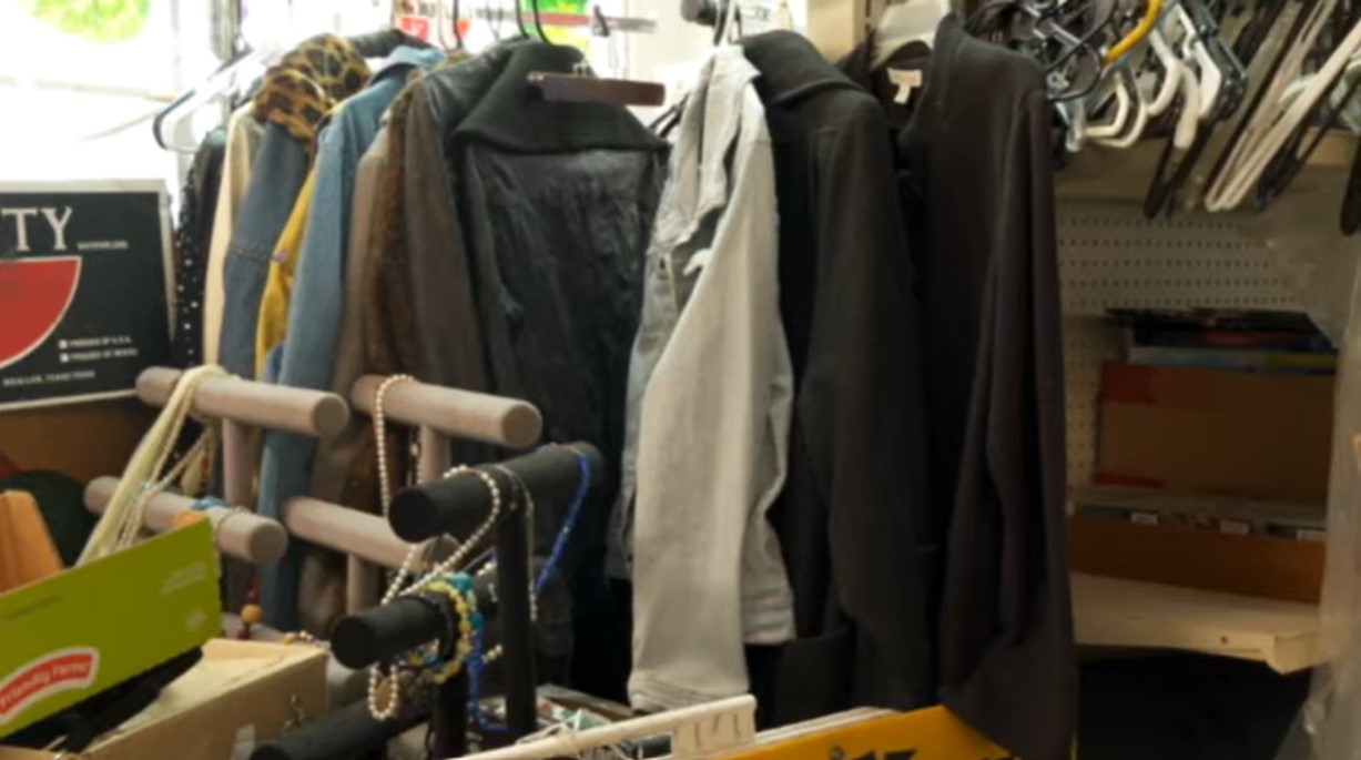 clothes, jewelry, hangers, and various items in a close space