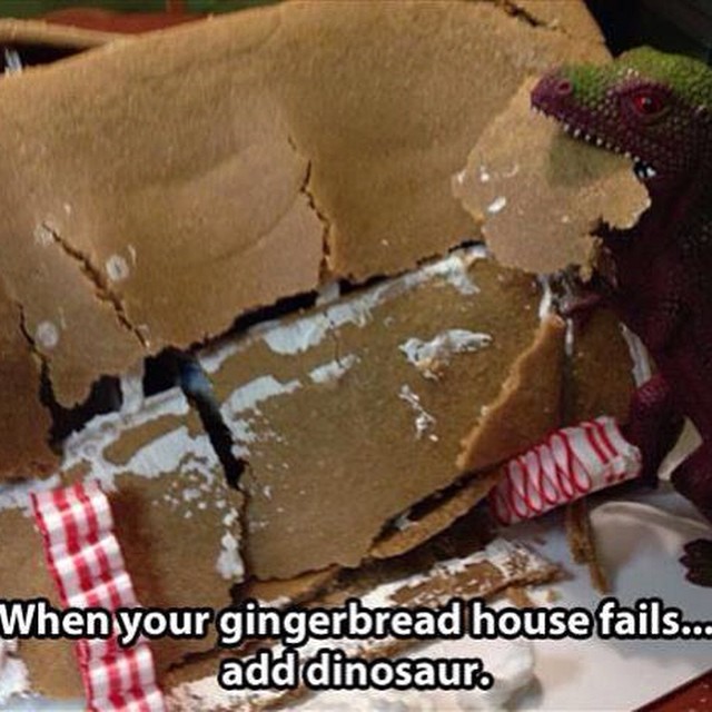 ginger bread house being eaten by plastic dinosaur