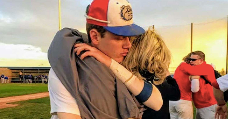 mom hugging son on baseball field