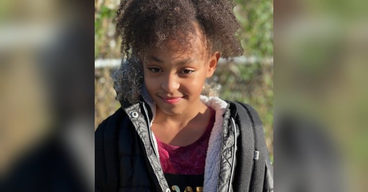 closeup of 9 year old jayline barbosa brandão standing outside and smiling