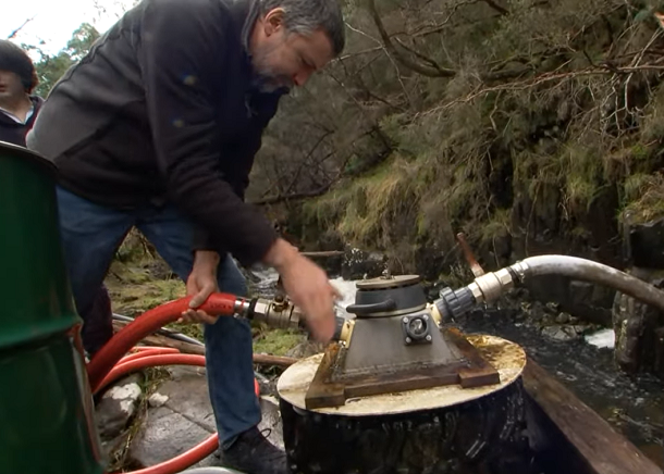 man works with water powered device