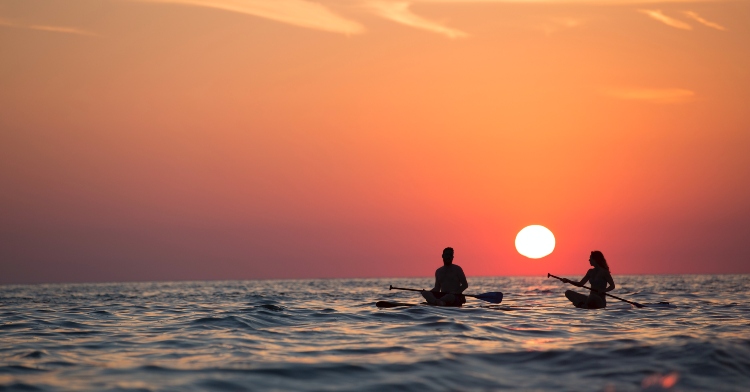 couple kayaking at sunset