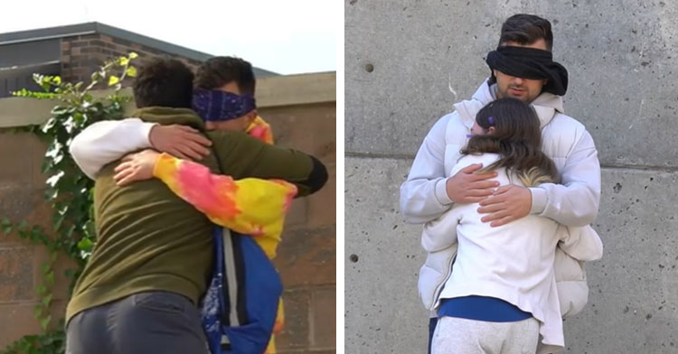 man wearing blindfold hugging two strangers