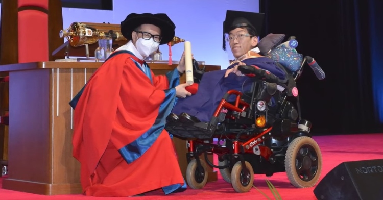 jonathan tiong receiving his diploma from national university of singapore on stage