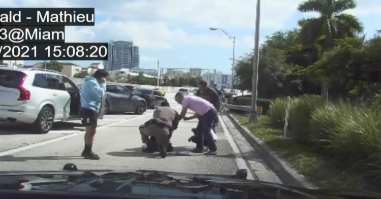 dashcam footage of trooper mathieu and a stranger saving the life of a choking one year old girl on the side of highway 95 in miami, florida