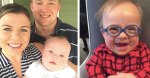 mom and dad smiling next to baby with down syndrome