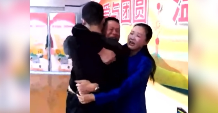 man named sun haiyang and a woman named peng siying crying as they hug their son sun zhuo 14 years after he was kidnapped