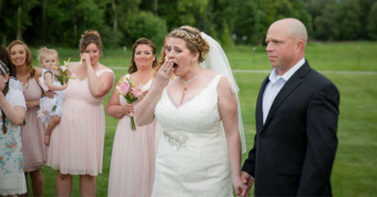bride gasping and holding hands with groom