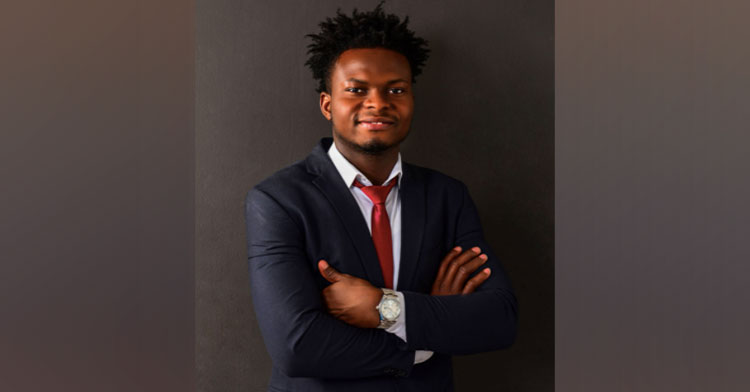 man wearing suit with arms crossed and smile on his face