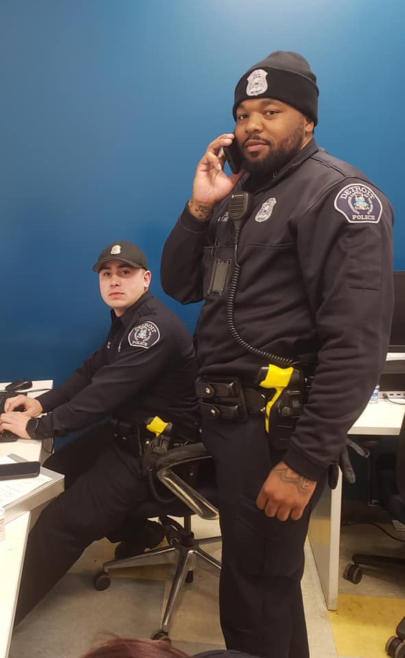 officer parrish and officer flannel of detroit on the phone and sitting at a desk