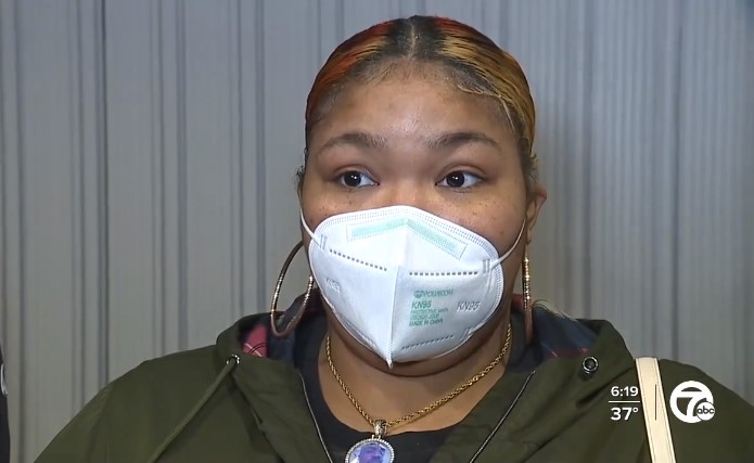 woman named shayla burleigh wearing a mask and talking with news stations