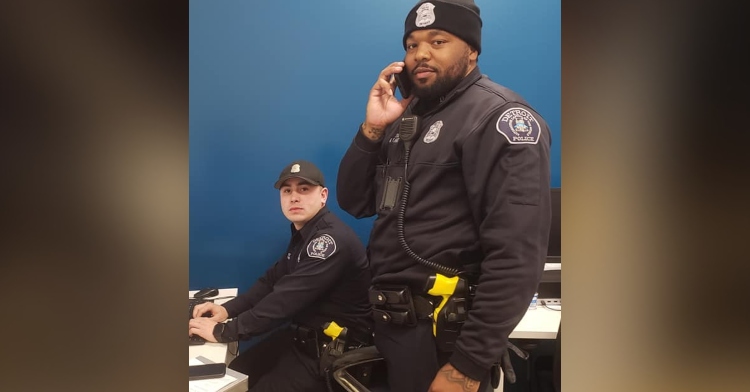 officer parrish and officer flannel of detroit on the phone and sitting at a desk