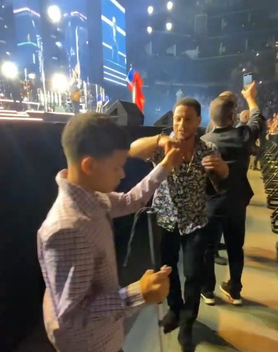 man named johhny rivera sr. dancing with his 16 year old son, johnny rivera jr. at a marc anthony concert 
