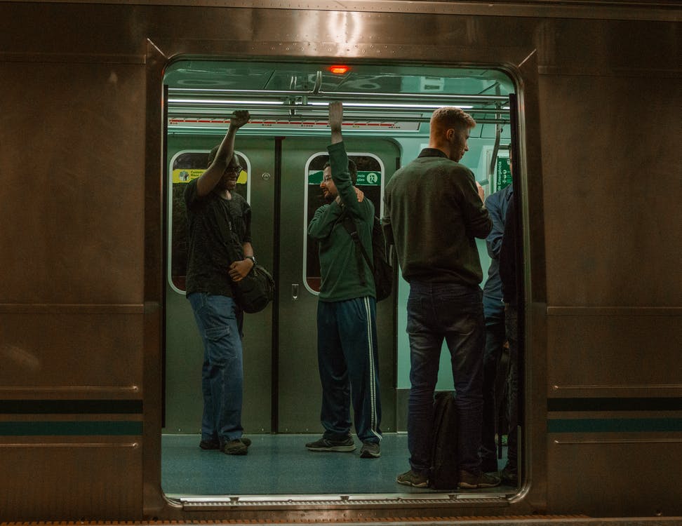 two men talking on subway