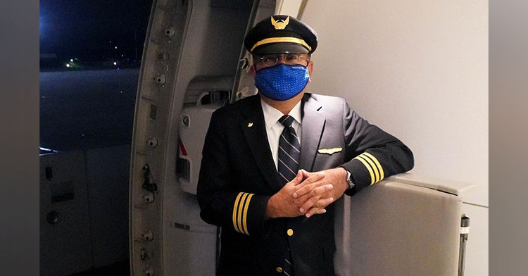Zak Khogyani standing in plane in pilot's uniform